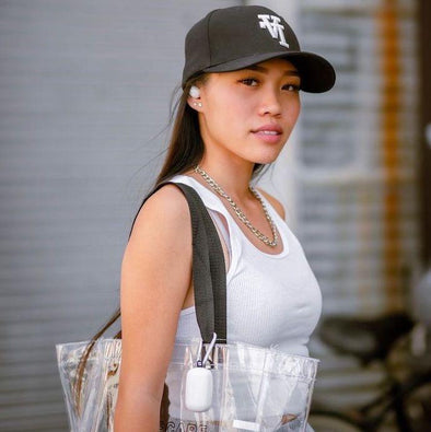 SOUL's influencer, @viamaeg is wearing a clear bag with her S-Gear clipped onto it and her headphones in her ear.